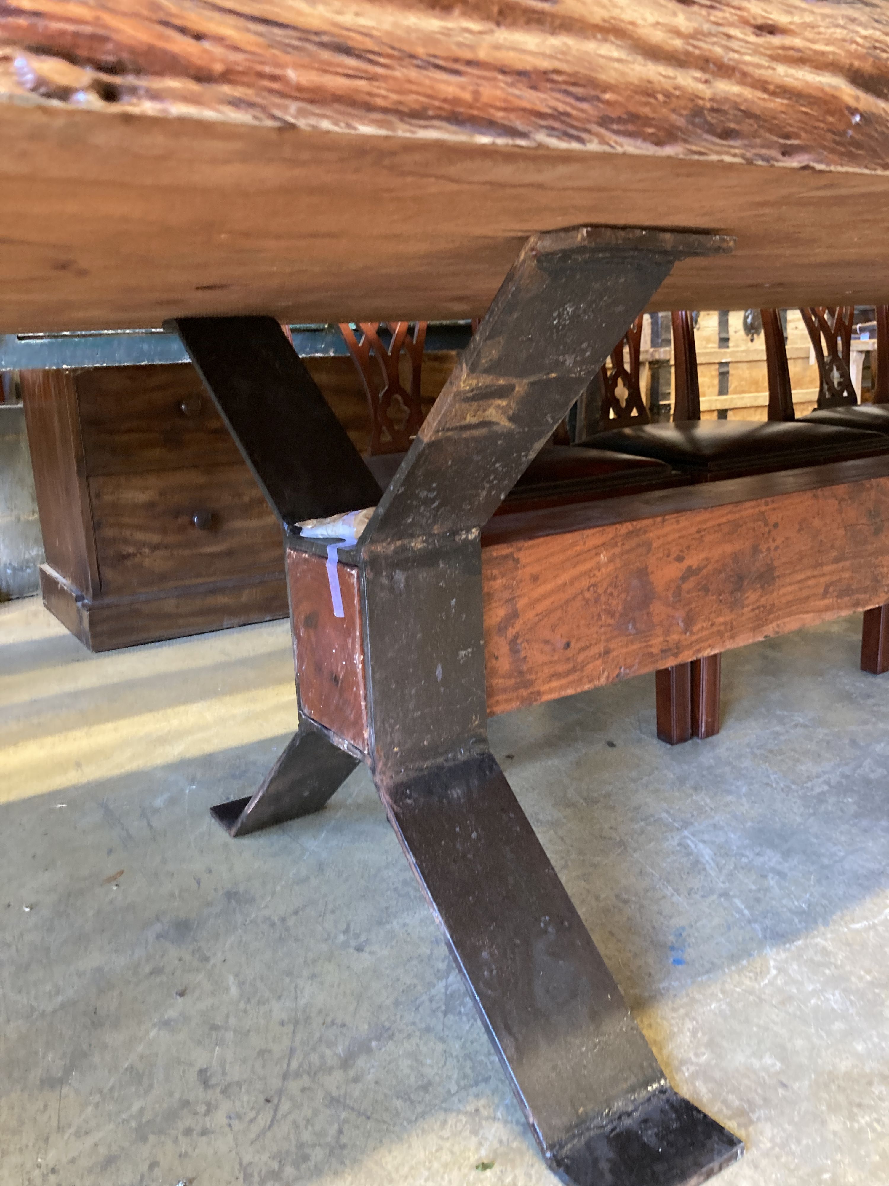 A South African Camelthorn hardwood dining table with a metal x-frame base, length 256cm, width 116cm, height 78cm